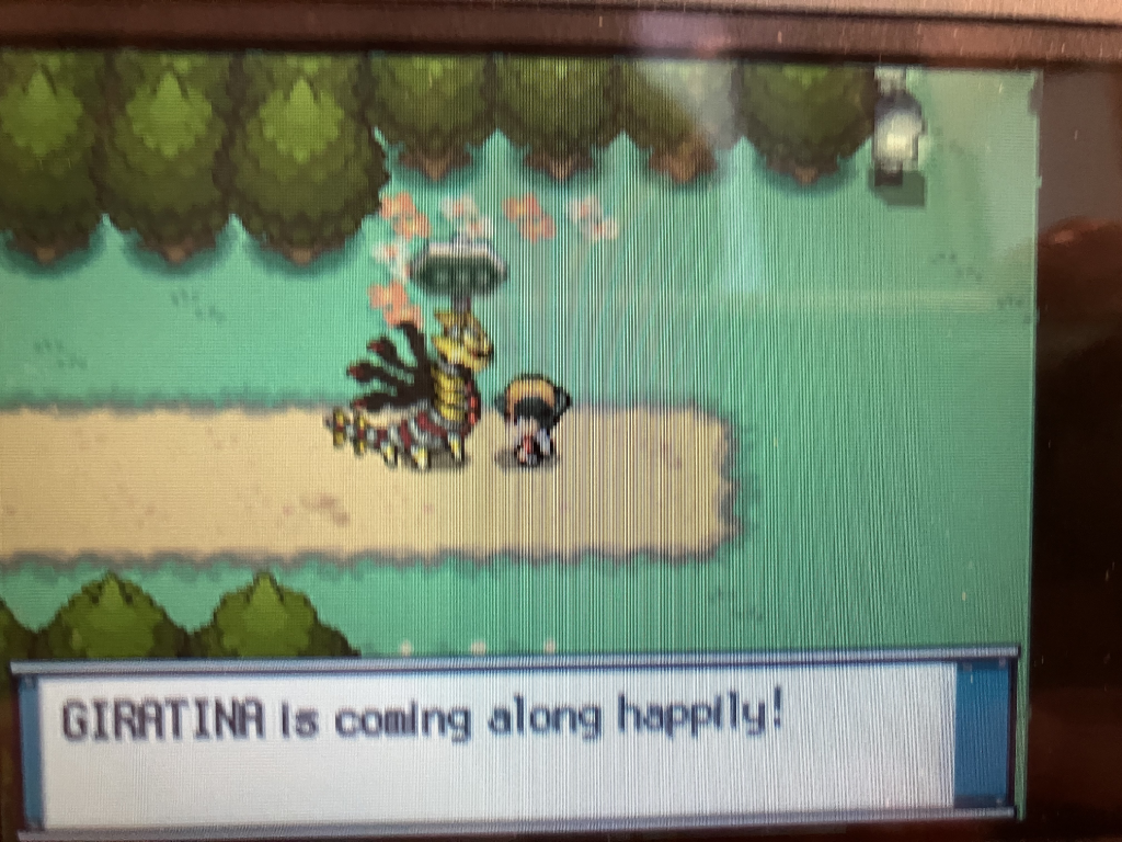 Origin Forme Giratina out of its Poké Ball, following the player in the overworld.