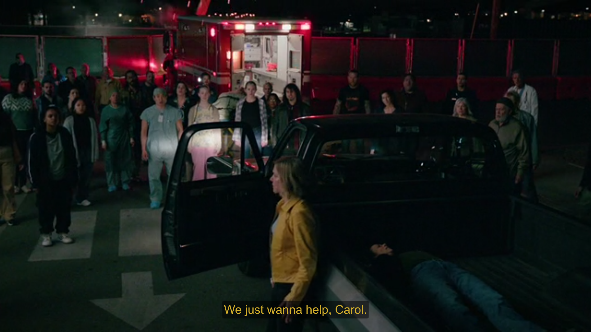 Carol standing near a crowd of people saying "We just wanna help, Carol."